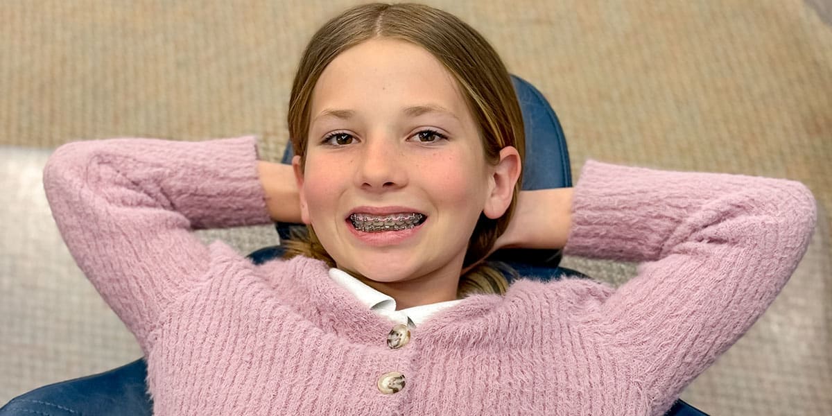 Siblings with braces smiling